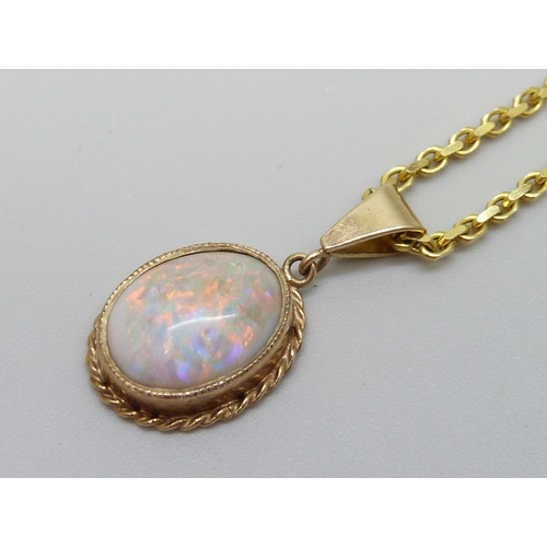 921 - A 9ct gold chain with a yellow metal set opal pendant, 9g total, 1.2 x 0.9cm opal, 60cm chain