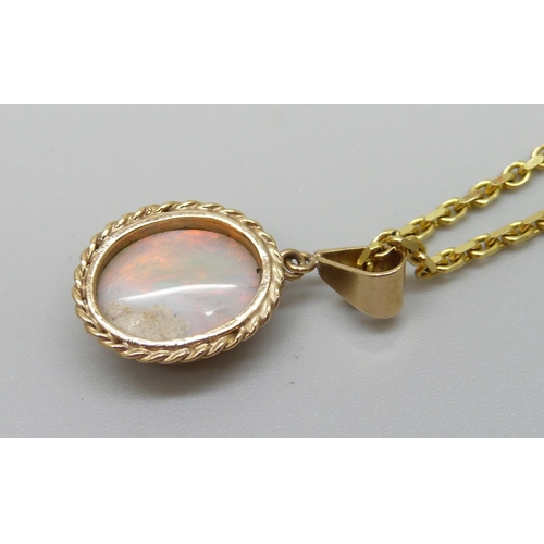 921 - A 9ct gold chain with a yellow metal set opal pendant, 9g total, 1.2 x 0.9cm opal, 60cm chain