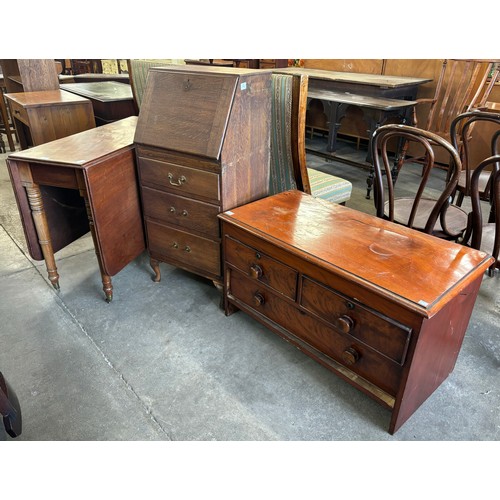 214 - An oak bureau, A Victorian mahogany drop leaf table and a chest of drawers