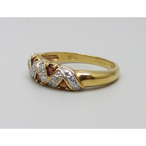 944 - A silver gilt garnet ring, U