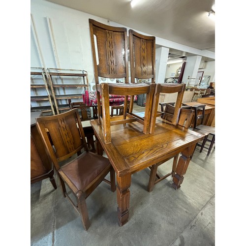 219 - An oak draw-leaf table and four chairs