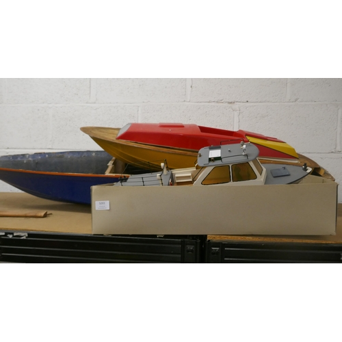 5093 - Three model boats including a model contrabande boat with display stand