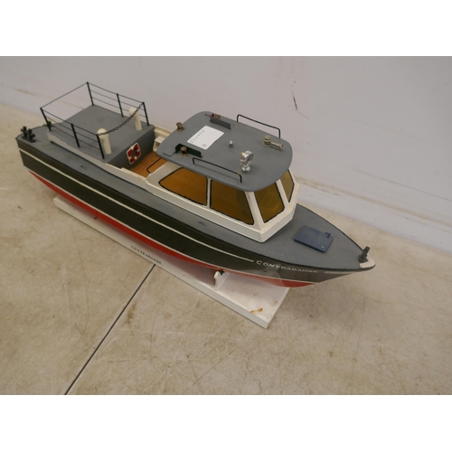 5093 - Three model boats including a model contrabande boat with display stand