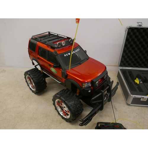 5094 - A remote control Land Rover model vehicle with remote, no charger and a remote control helicopter in... 