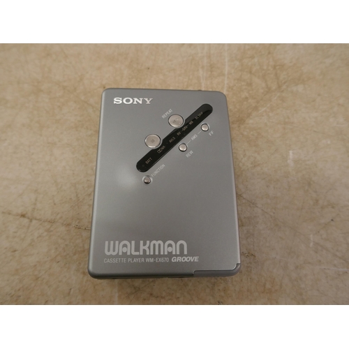 5082 - A Sony WM-EX670 Walkman cassette player with rechargeable battery, battery charger and headphones