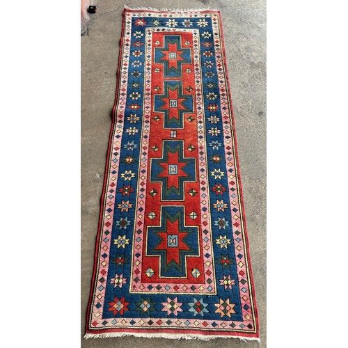 232 - A Turkish red ground runner rug, 83 x 247cms