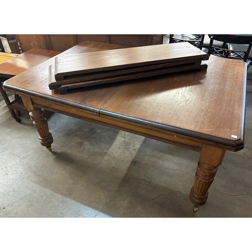 249 - A Victorian walnut extending dining table