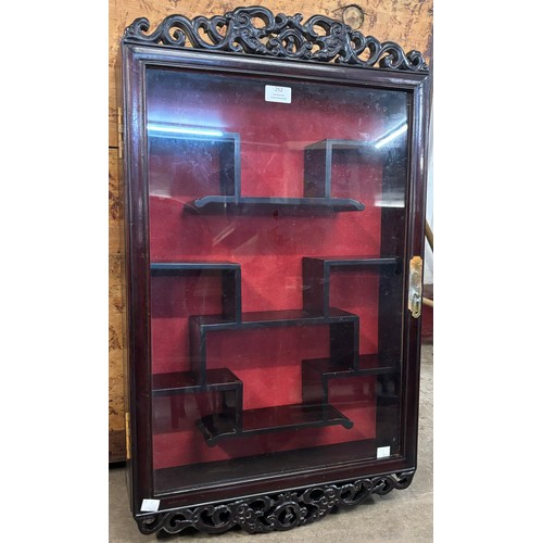 252 - A Chinese hardwood wall hanging display cabinet