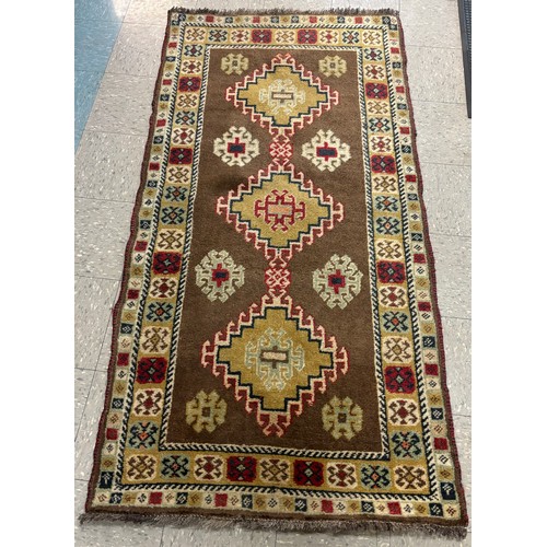 255 - An Eastern hand knotted green ground rug