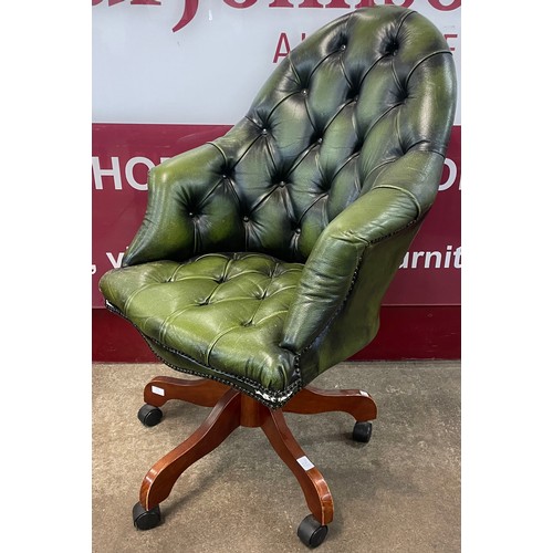 110 - A mahogany and green leather Chesterfield revolving desk chair