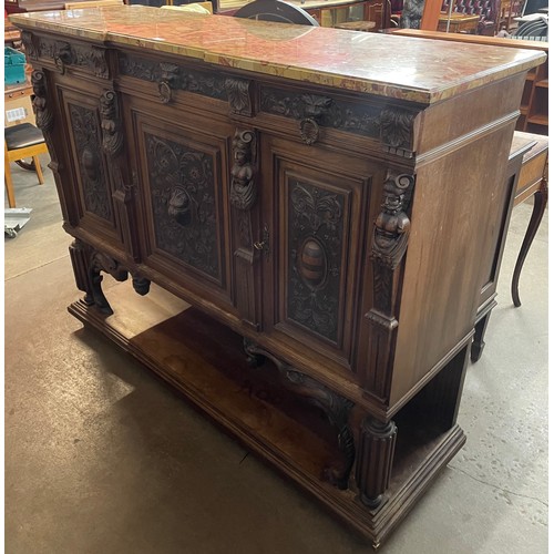 121 - A 19th Century French carved oak and marble topped three door cabinet