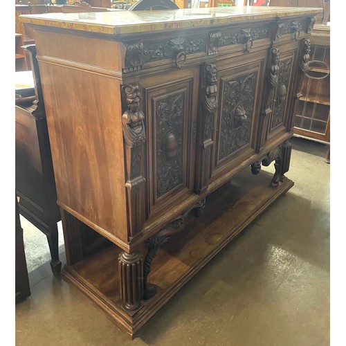 121 - A 19th Century French carved oak and marble topped three door cabinet