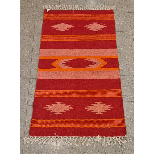 256 - An eastern multi coloured rug, 90 x 161cms