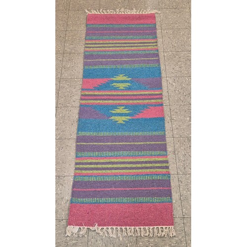 257 - An eastern multi coloured runner rug, 66 x 211cms