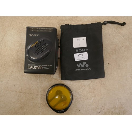 5079 - A Sony WM-FX36 Walkman radio cassette player and a set of Sony earphones