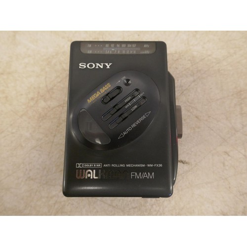 5079 - A Sony WM-FX36 Walkman radio cassette player and a set of Sony earphones