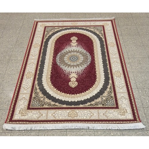 264 - A Kashan Shahkar Dorrin pattern red ground rug, 228 x 152cms