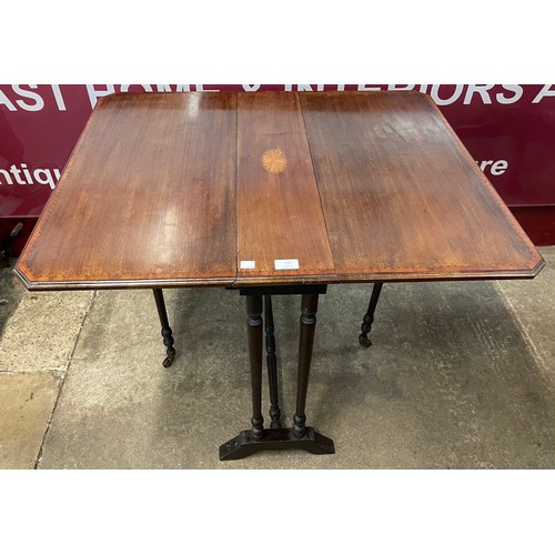 131 - An Edward VII inlaid mahogany Sutherland table