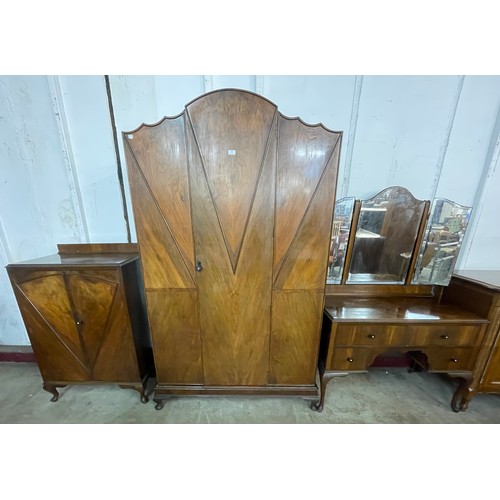 142 - An Art Deco figured walnut bedroom suite, comprising; tallboy, wardrobe and a dressing table