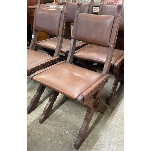 147 - A set of four Arts and Crafts oak X-frame dining chairs