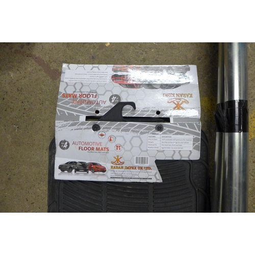 5337 - A pair of stainless Rhino roof bars and a set of car mats