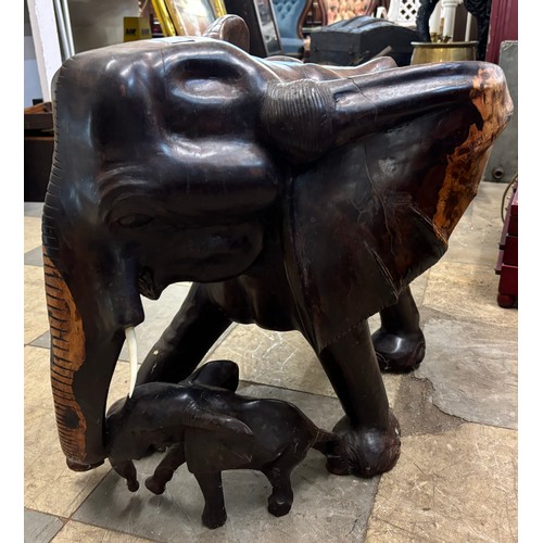 286 - A large carved hardwood figure of an elephant and calf, with faux ivory tusks