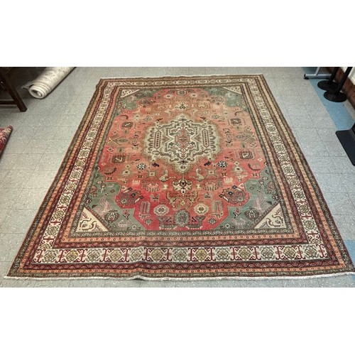 233B - A large Eastern terracotta ground rug, 375 x 330cms