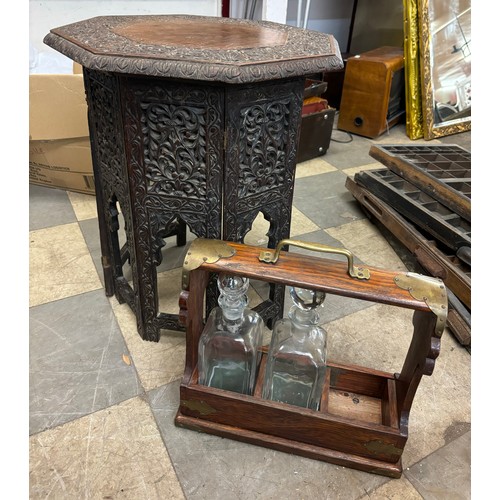 287 - A mahogany tantalus with two bottles and an Indian carved wood occasional table