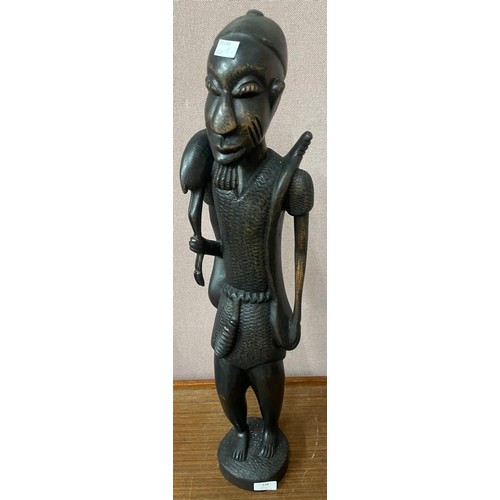 338 - An African carved hardwood figure of a man