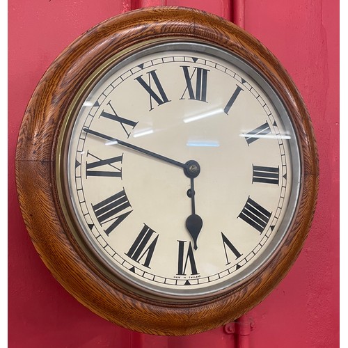 350B - An early 20th Century oak circular wall clock