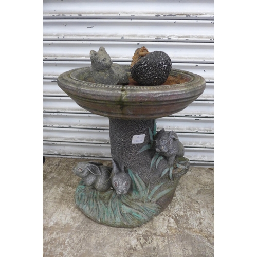 5166 - A stone bird bath, hedgehog, chimpanzees and one other ornament