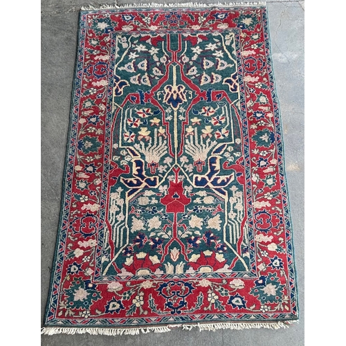 255B - An Eastern red ground rug 226 x 147cms