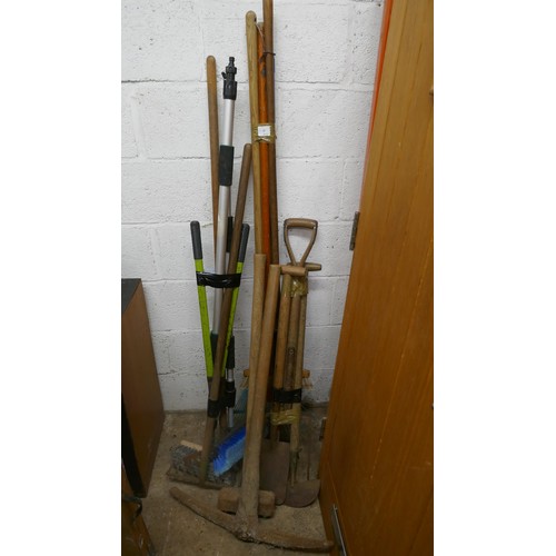 5188 - A quantity of heavy duty tools including a pick axe, a hammer, brushes, rake, etc.