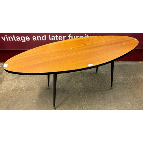 13 - A walnut and black oval coffee table