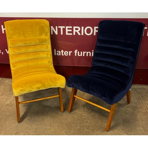 23 - A pair of teak and fabric upholstered fireside chairs