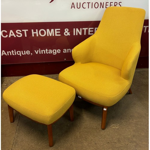 40 - A Danish style teak and mustard fabric upholstered armchair and footstool