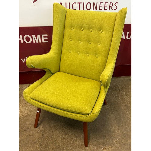 47 - A Danish style teak and lime green fabric upholstered armchair