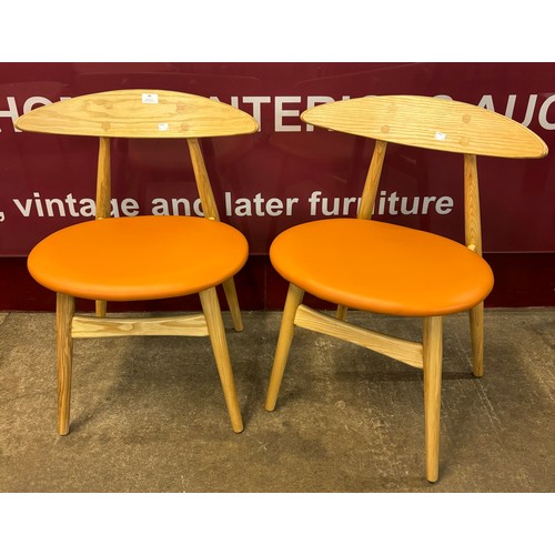 49 - A pair of Danish style ash and tan vinyl dining chairs