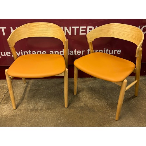 50 - A pair of Danish style ash and tan vinyl dining chairs