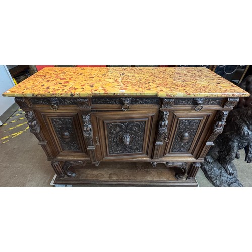 74 - A 19th Century French carved oak and marble topped three door cabinet