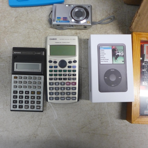 5049 - A black 120gb iPod Classic, a Panasonic camera, a Sony digital photo frame, calculators, a framed Si... 