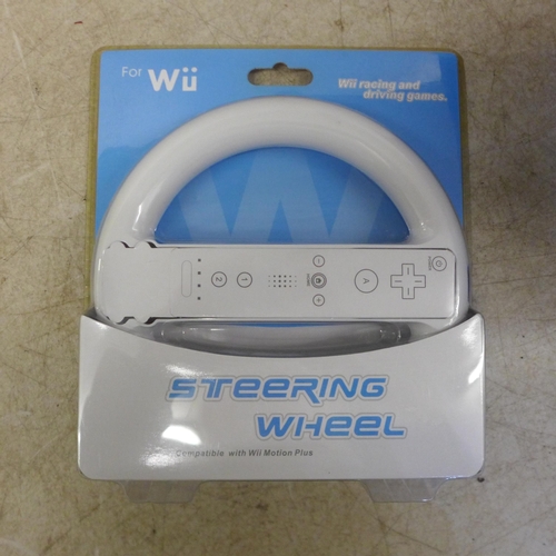 5070 - A Nintendo Wii and various accessories including a mega sports pack, a steering wheel, a copy of Wii... 