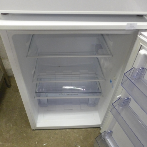 5121 - An Indesit freestanding under counter fridge