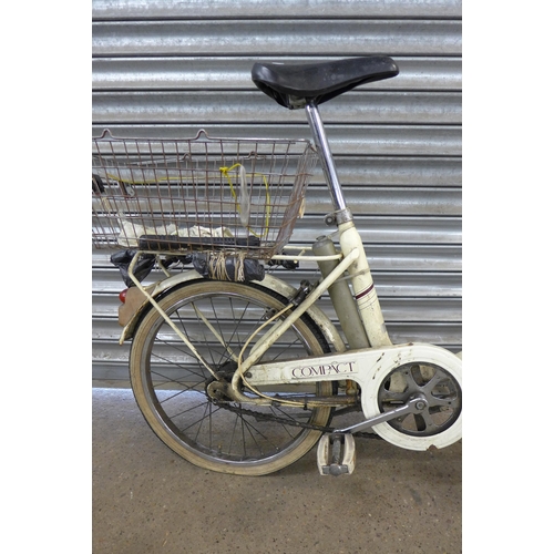 5134 - A vintage Raleigh Compact folding bike with panier rack, rear mounted basket and front headlamp