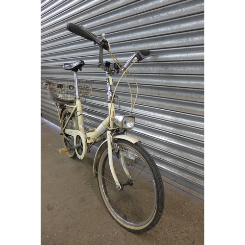 5134 - A vintage Raleigh Compact folding bike with panier rack, rear mounted basket and front headlamp