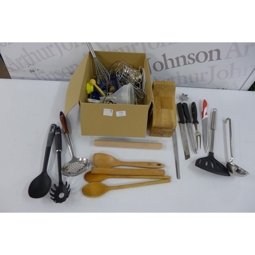 5228 - A quantity of kitchen items including a wooden knife block, slotted spoons, rolling pins, knives, a ... 