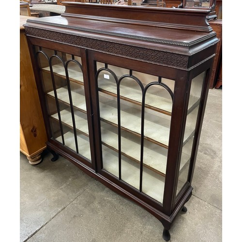 97 - An Edward VII carved mahogany two door display cabinet