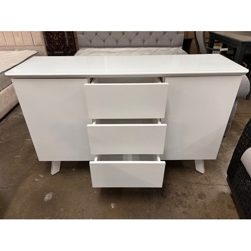 3109 - A white glass top side board with push to open doors and drawers