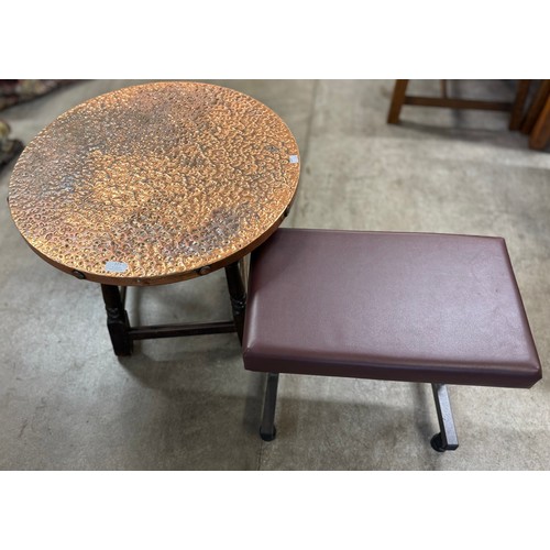 177 - A hammered copper circular occasional table and a brown leather topped footstool