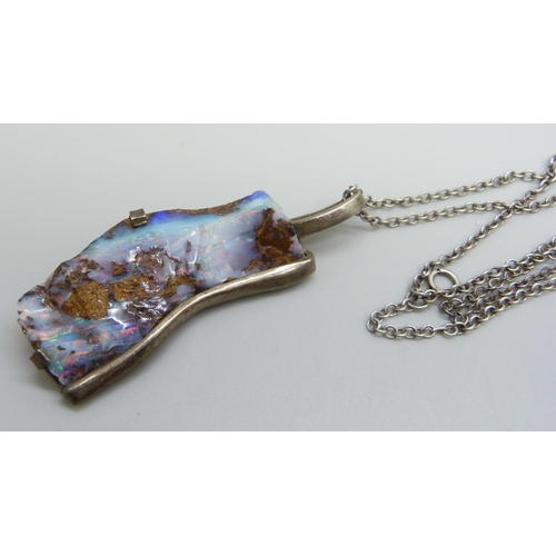 1009 - A silver mounted large rough opal studio pendant on a silver chain, opal 45mm